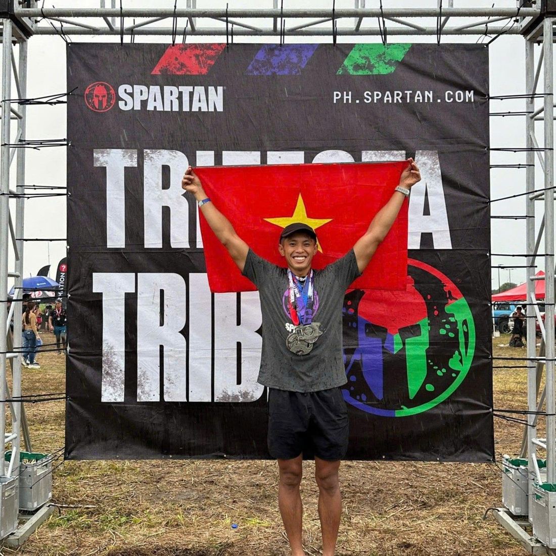 Holding the Vietnamese flag with three Spartan medals